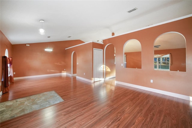 spare room with hardwood / wood-style flooring and lofted ceiling