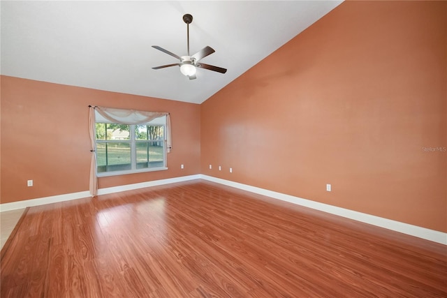 empty room featuring ceiling fan, high vaulted ceiling, and light wood-type flooring