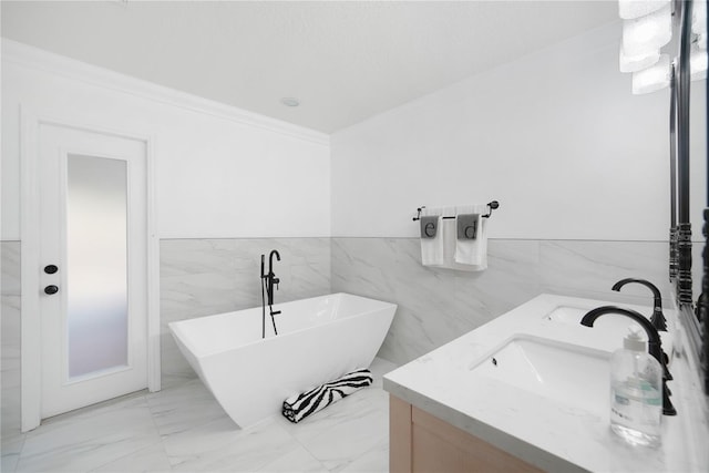 bathroom with a bath, vanity, tile walls, and ornamental molding