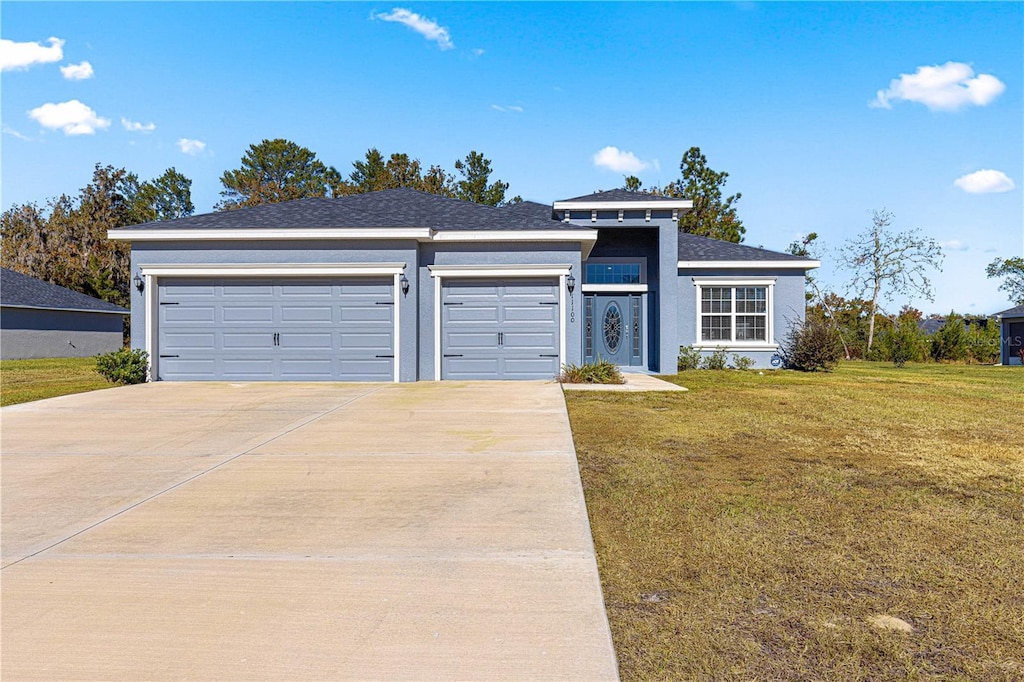 view of front facade featuring a front lawn and a garage