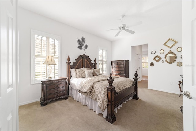 bedroom with ceiling fan and light colored carpet