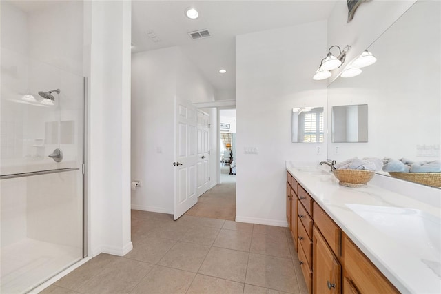 bathroom with tile patterned flooring, vanity, and an enclosed shower