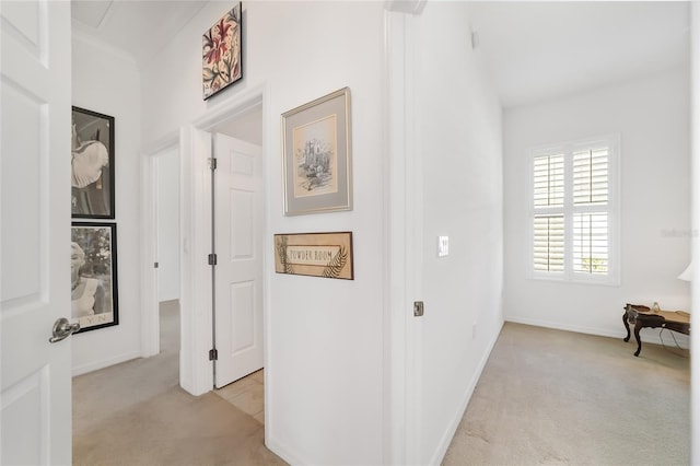 hallway featuring light colored carpet