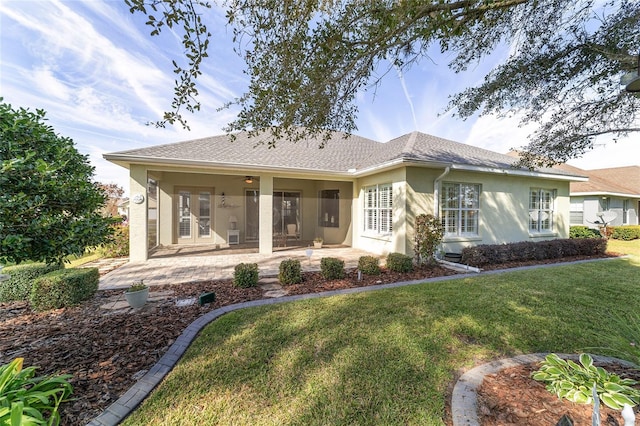 back of house featuring a patio area and a yard