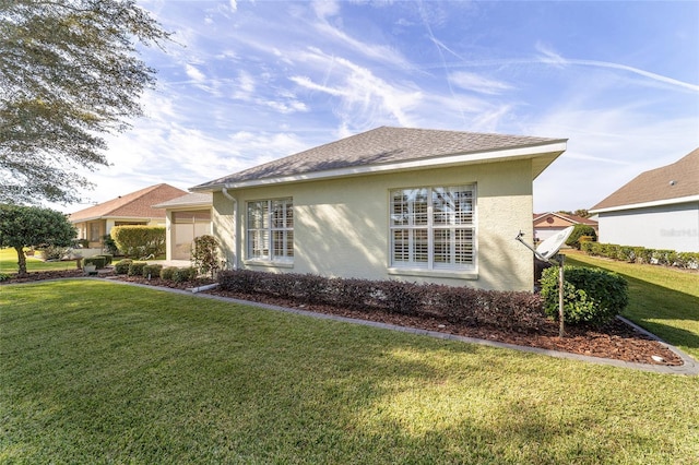 view of property exterior with a lawn