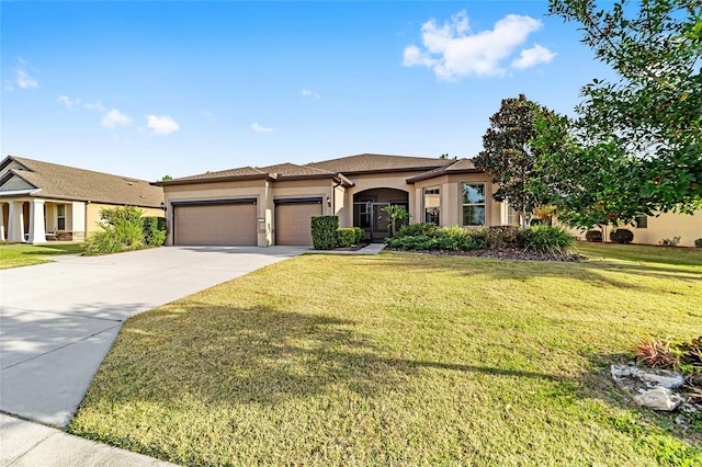 view of front of property featuring a front lawn and a garage