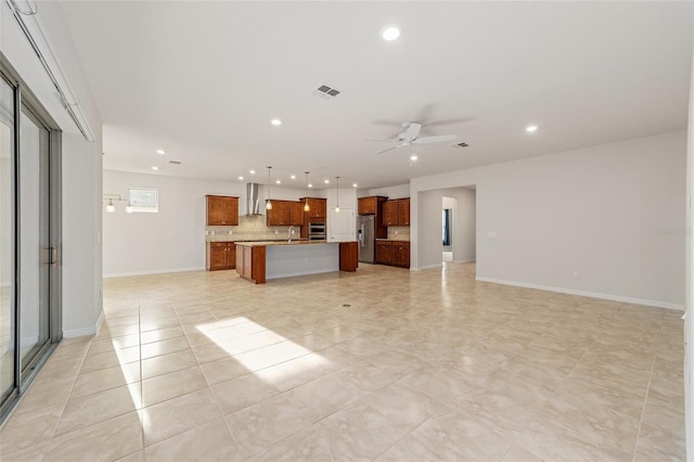 unfurnished living room with ceiling fan and light tile patterned floors