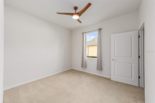 unfurnished room featuring light carpet and ceiling fan