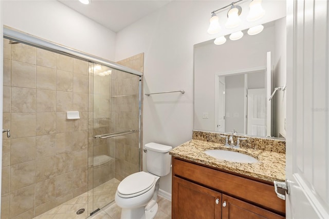 bathroom featuring tile patterned floors, vanity, toilet, and walk in shower