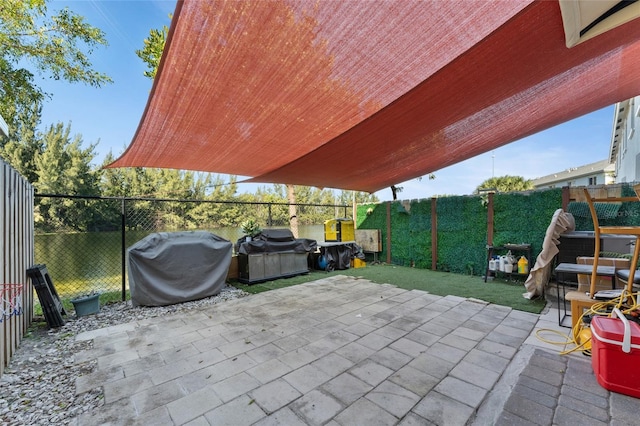 view of patio featuring a fenced backyard and a grill