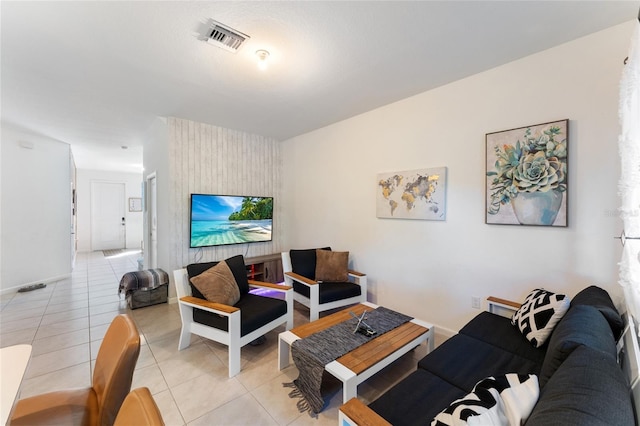 living area with visible vents and light tile patterned floors