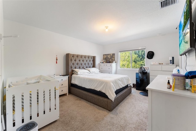 bedroom with light colored carpet and visible vents