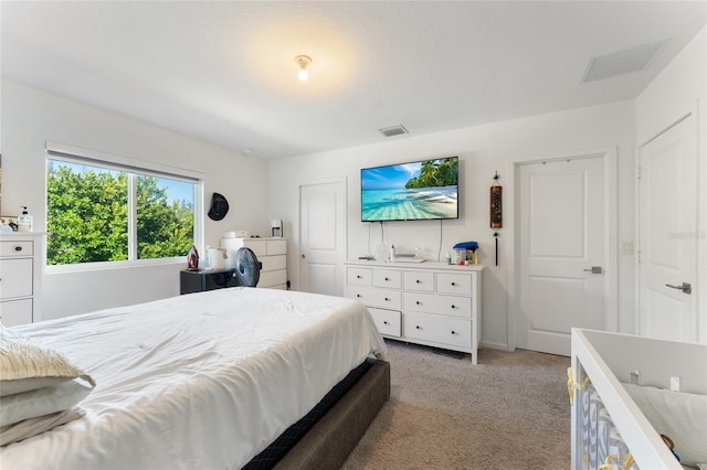 bedroom featuring visible vents and light colored carpet