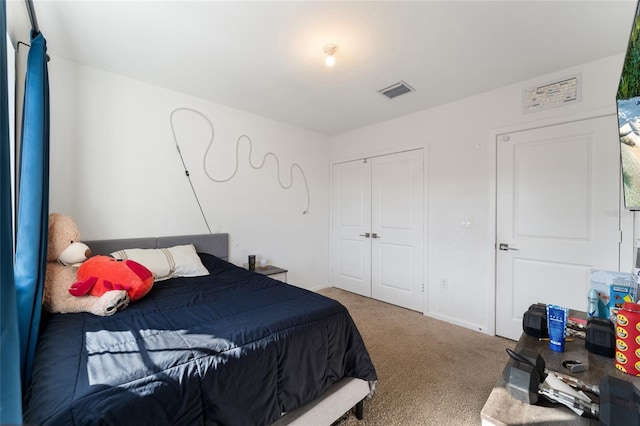 carpeted bedroom with a closet, visible vents, and baseboards