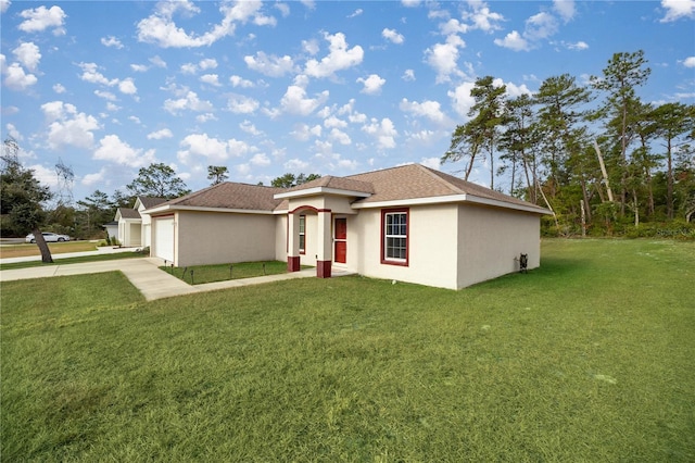 view of front of house featuring a garage and a front lawn