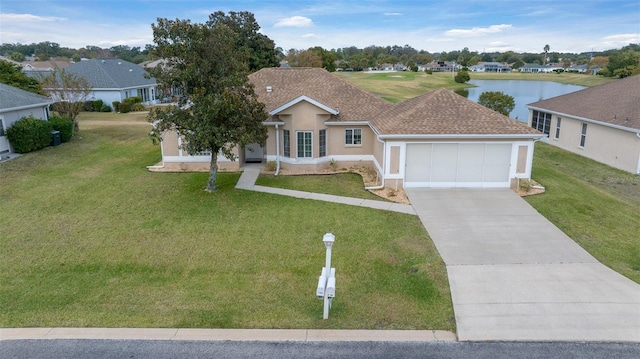 ranch-style house with a water view, a front yard, and a garage