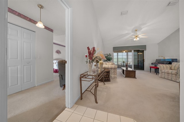 carpeted living room featuring vaulted ceiling and ceiling fan