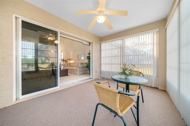 sunroom / solarium featuring ceiling fan