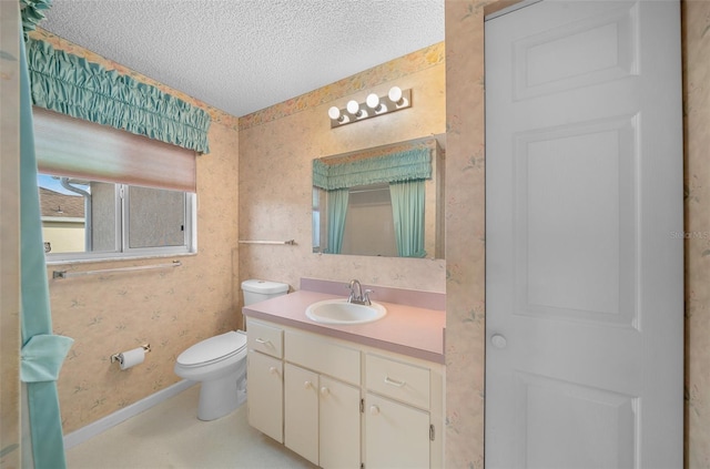 bathroom with vanity, a textured ceiling, and toilet