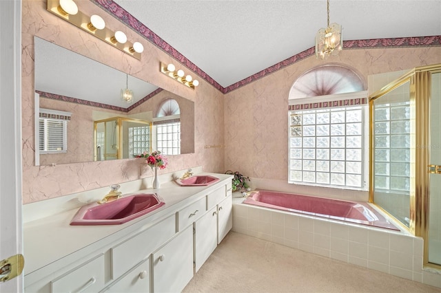 bathroom with vanity, separate shower and tub, lofted ceiling, and a textured ceiling