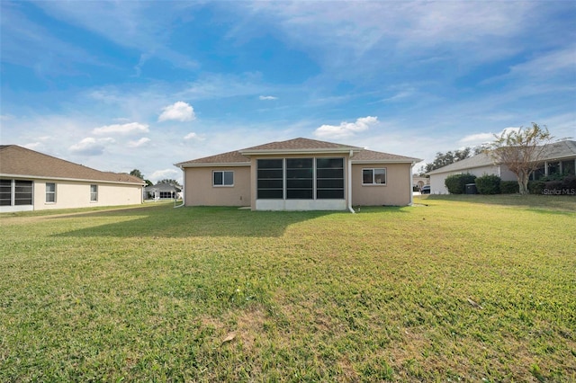 rear view of property with a yard