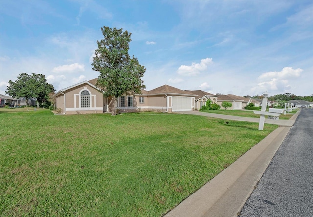 ranch-style home featuring a garage and a front yard