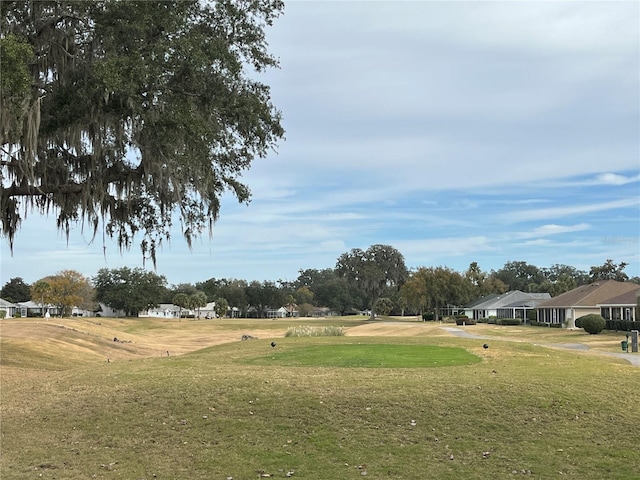 view of property's community with a lawn