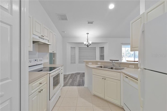 kitchen featuring lofted ceiling, white appliances, sink, hanging light fixtures, and light tile patterned flooring