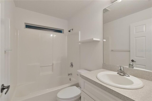 full bathroom featuring shower / washtub combination, vanity, and toilet