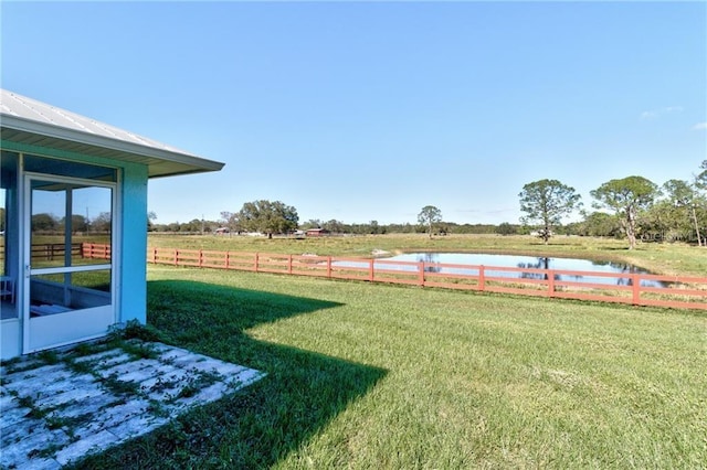 view of yard with a rural view and a water view