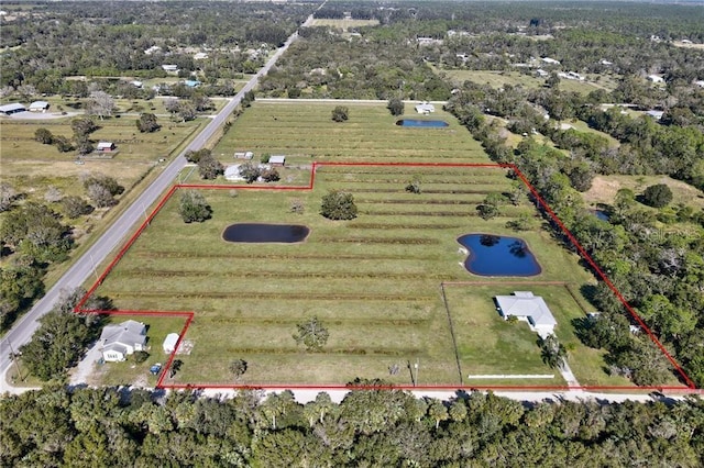 birds eye view of property with a rural view