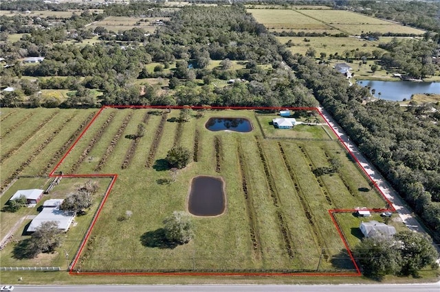 birds eye view of property with a rural view and a water view