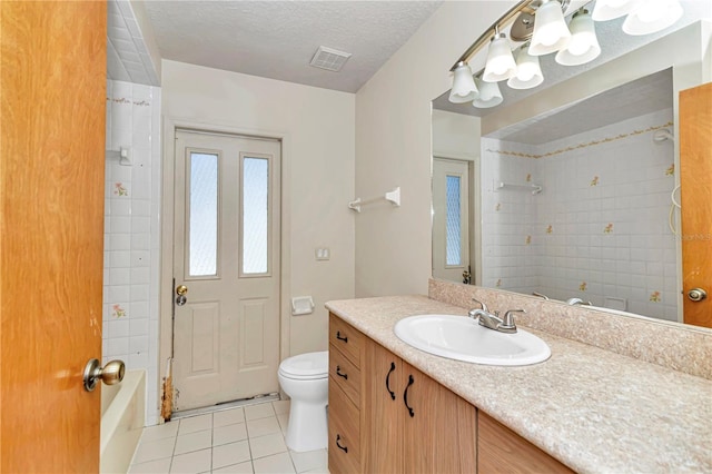 full bathroom with vanity, a textured ceiling, tiled shower / bath combo, tile patterned flooring, and toilet