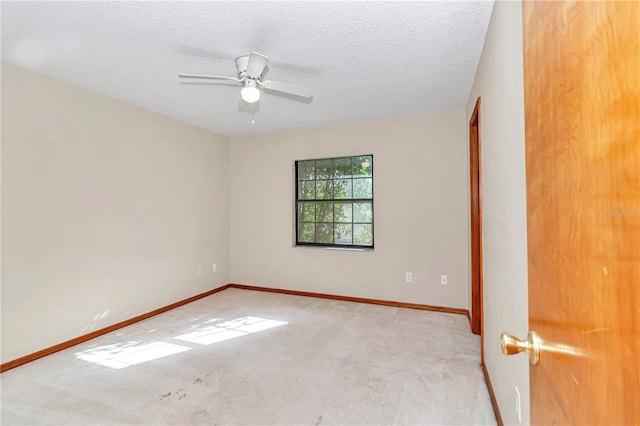 carpeted empty room featuring a textured ceiling and ceiling fan