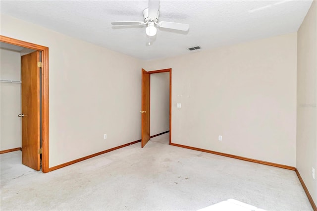 unfurnished bedroom with a textured ceiling, a closet, and ceiling fan