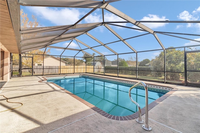 view of swimming pool with glass enclosure and a patio area