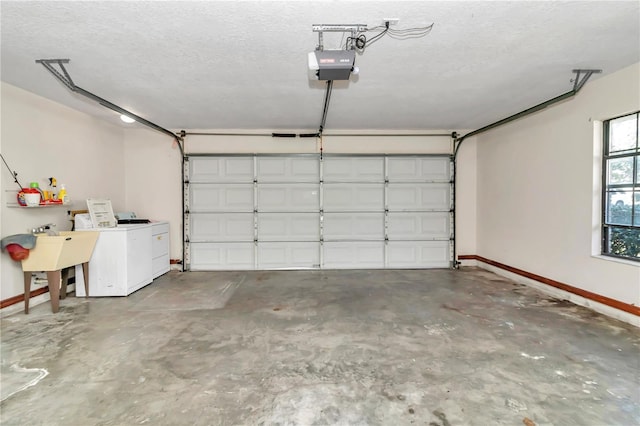 garage featuring separate washer and dryer, sink, and a garage door opener