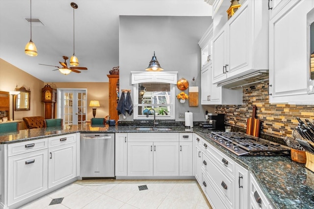 kitchen featuring ceiling fan, sink, dark stone countertops, white cabinets, and appliances with stainless steel finishes