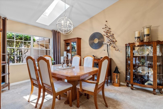 dining room with a skylight, light carpet, and a notable chandelier