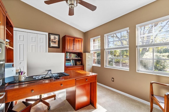 office space featuring light colored carpet, vaulted ceiling, and ceiling fan