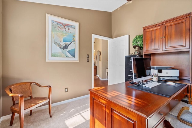 carpeted home office with lofted ceiling