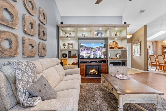 living room with hardwood / wood-style floors and ceiling fan