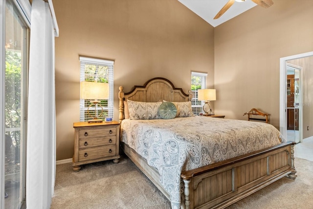 carpeted bedroom featuring access to outside, high vaulted ceiling, and ceiling fan