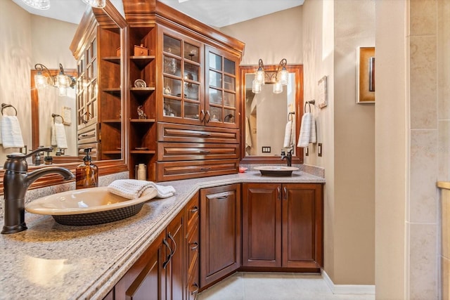 bathroom with tile patterned floors, vanity, and vaulted ceiling