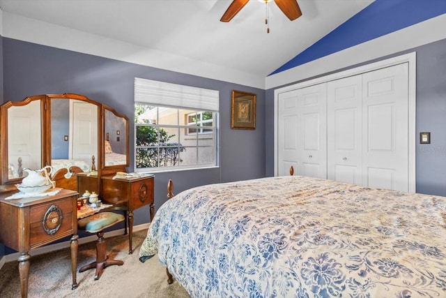 bedroom with carpet flooring, ceiling fan, a closet, and vaulted ceiling