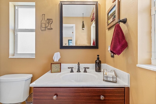 bathroom featuring vanity and toilet