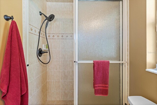 bathroom with toilet and walk in shower