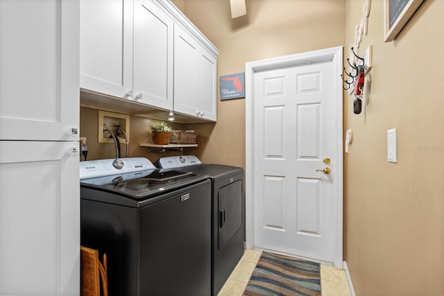 clothes washing area featuring light tile patterned flooring, cabinets, and independent washer and dryer