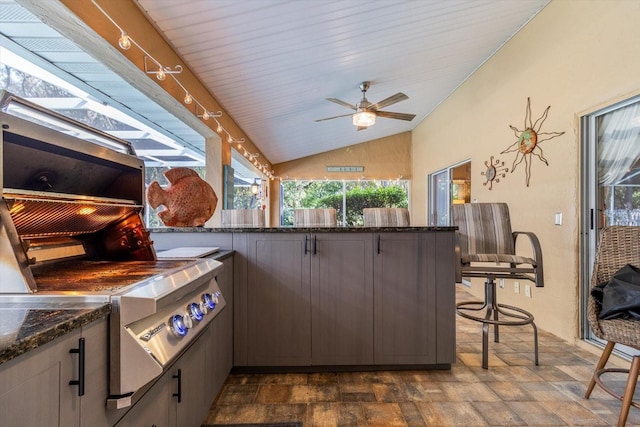 view of patio / terrace featuring ceiling fan and a bar