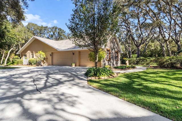 view of front of property with a garage and a front lawn